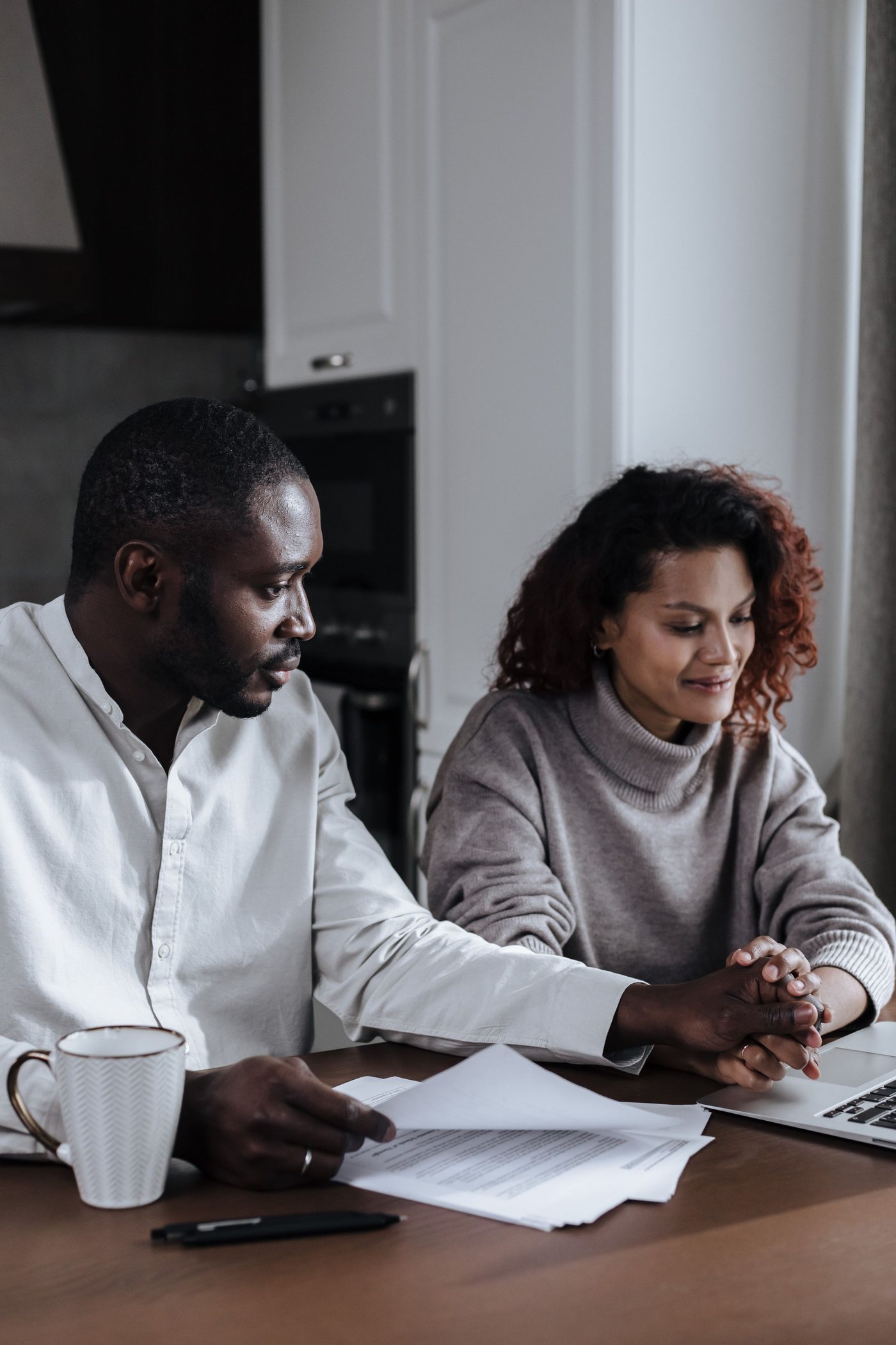 A couple going through paperwork together at home
