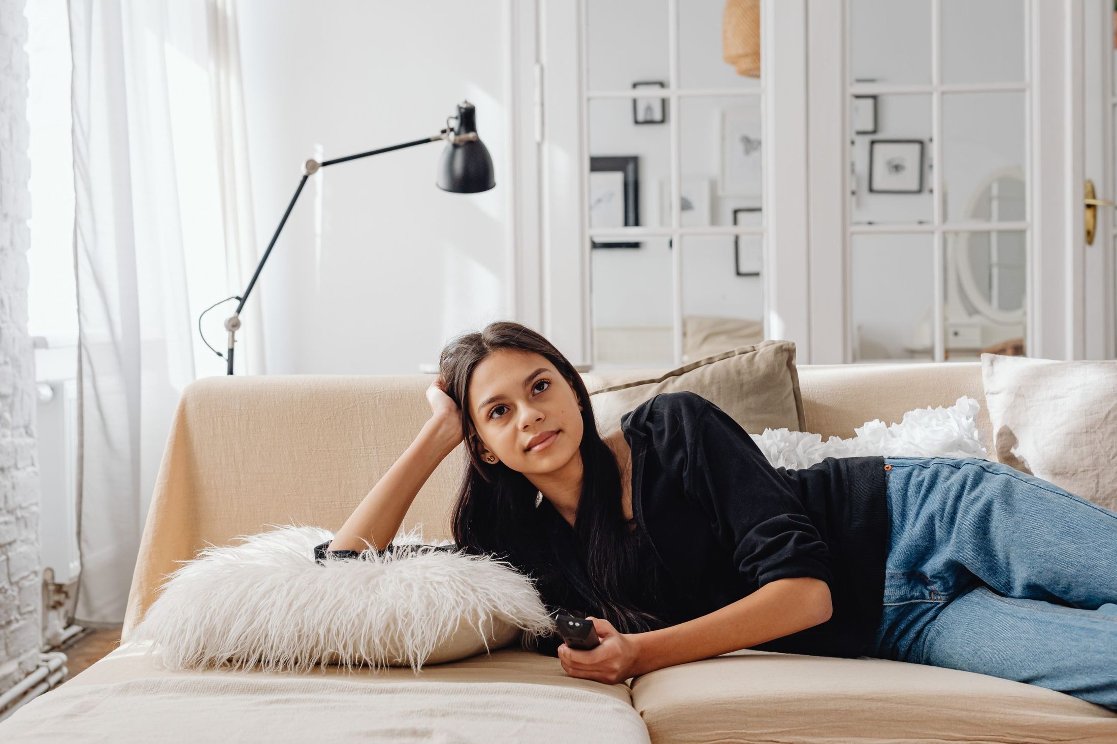 A woman resting on the sofa at home