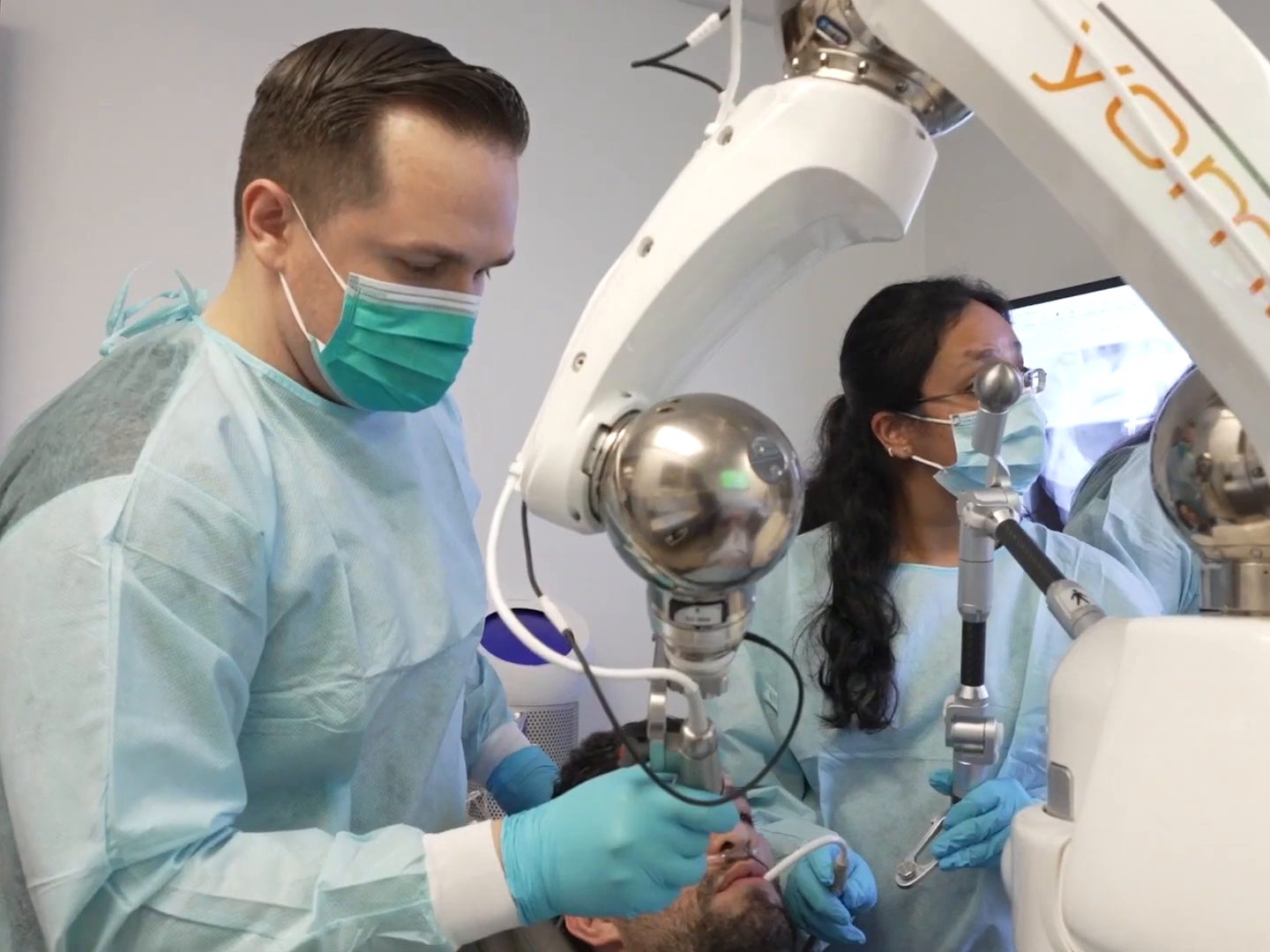 Dr. Tony Barriere and his assistant placing an implant with the Yomi dental robot at West LA Implants