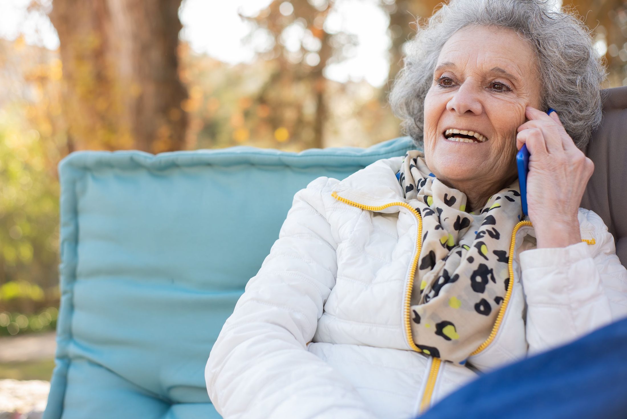 A smiling woman talking on her phone