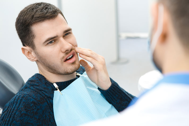 Dental Patient Is Suffering From Dental Pain During A Dental Consultation